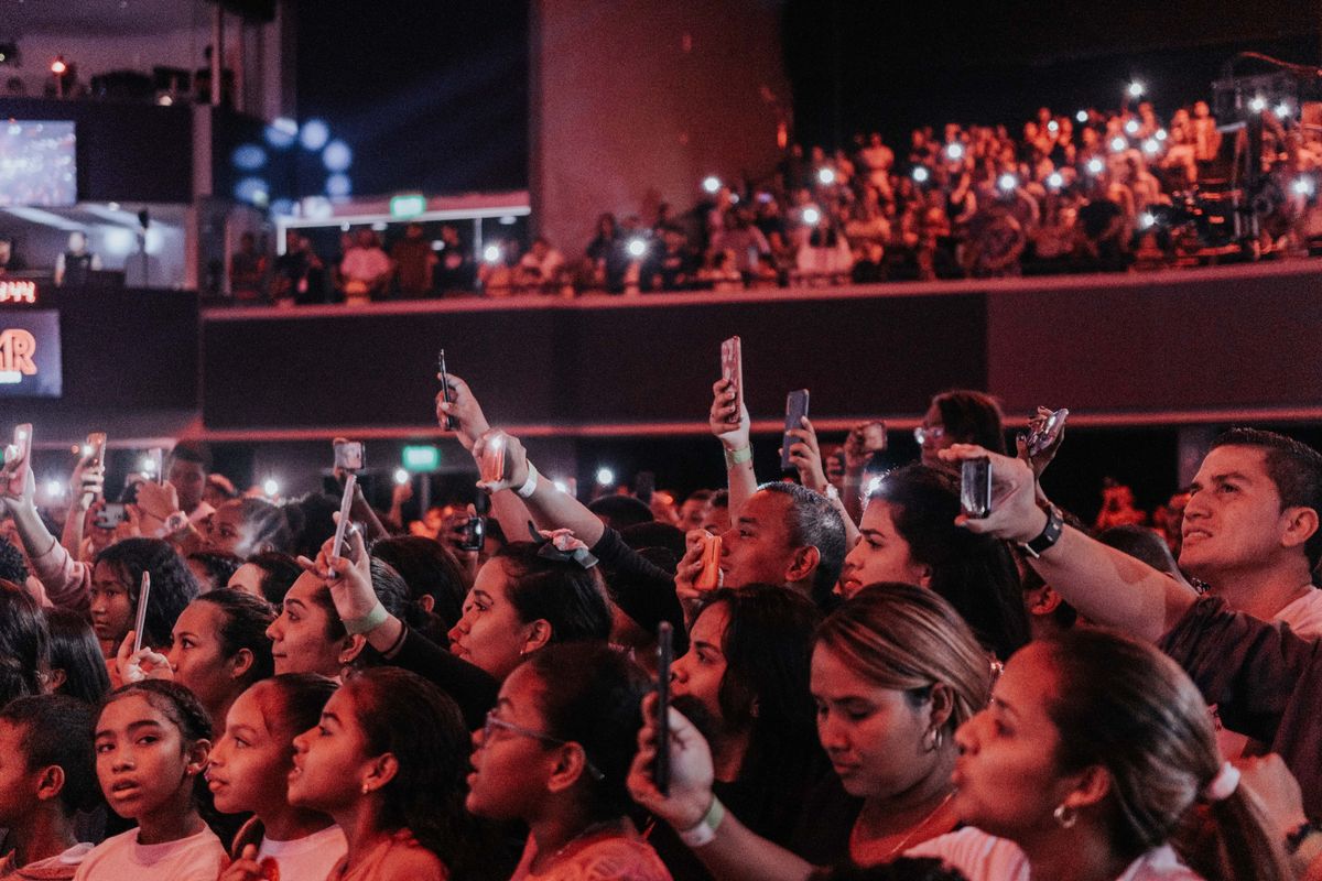 A concert crowd holding up phones